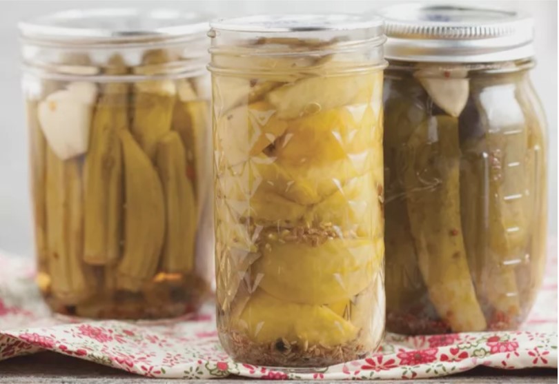 A picture containing cup, pickle, drink, jar Description automatically generated